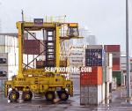 ID 1868 PORT OF AUCKLAND, NZ - A straddle carrier manoeuvring among container stacks, Axis Fergusson Container Terminal.